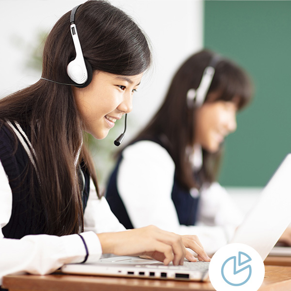 Students wear headsets while testing on laptops